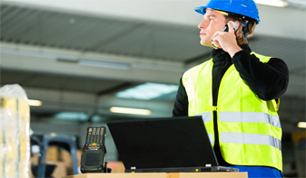 manufacturing worker on mobile phone