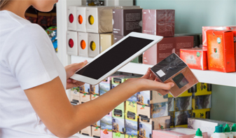 retail worker using tablet to look up item