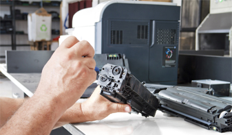 man repairing printer