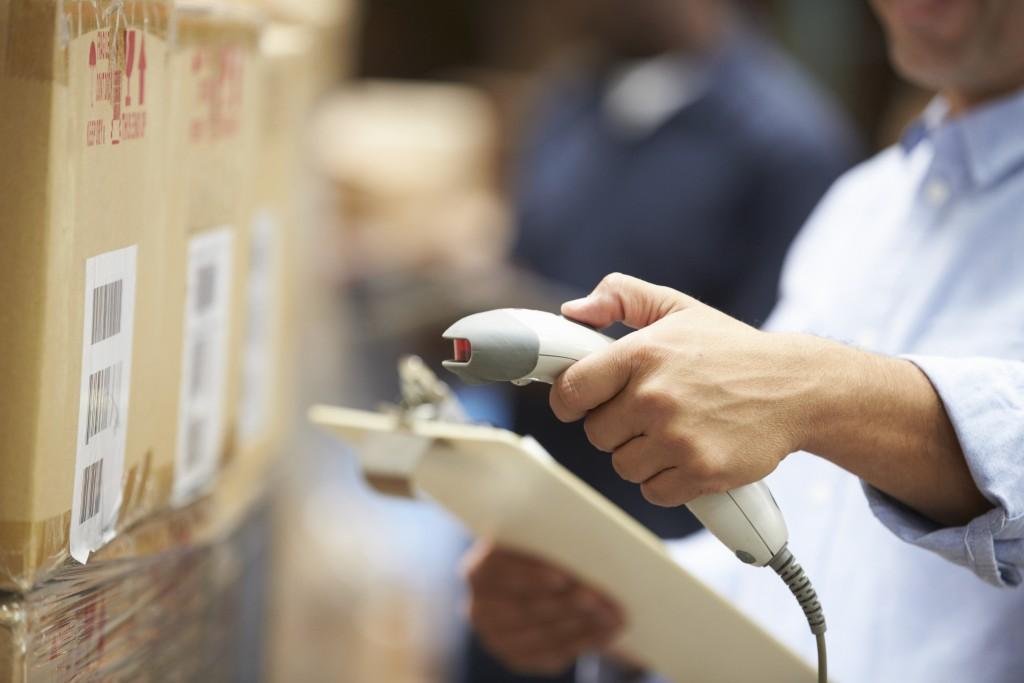 Worker Scanning Package In Warehouse