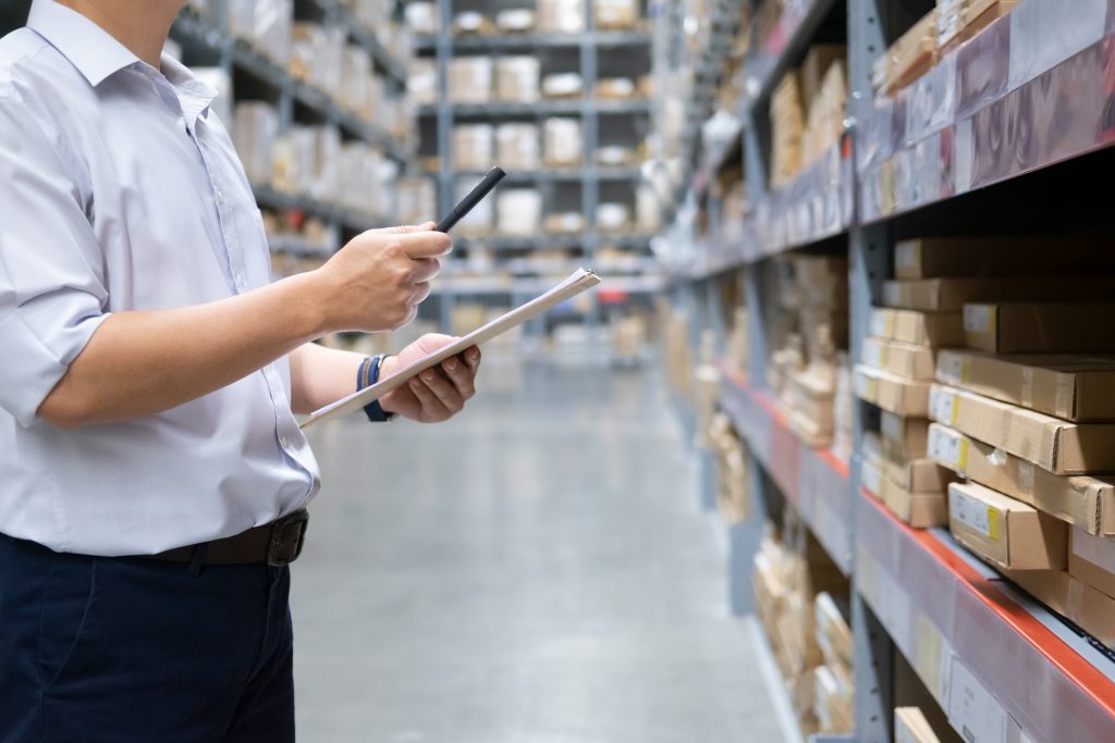 Man Checking Stock in Warehouse