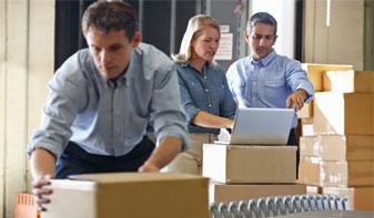 workers boxing up stock in warehouse