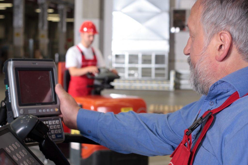 Warehouse worker operating a vehicle mounted barcode computer