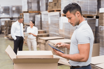 man checking stock in warehouse