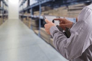 man in warehouse checking stock