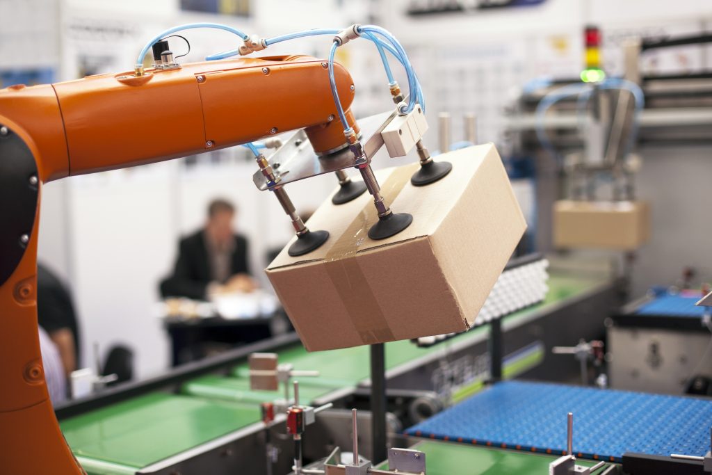 Packaging Line with Robotic Arm at Work.