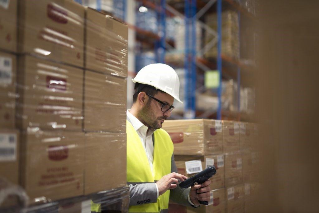 man using scanner in warehouse