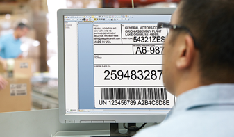 man designing barcodes on computer screen
