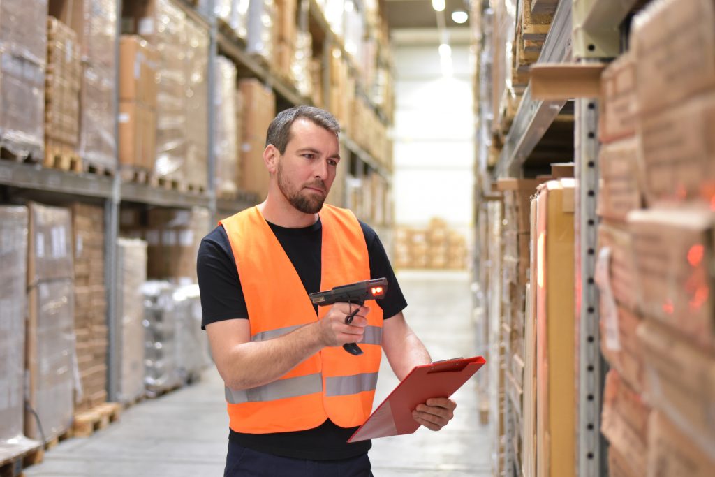 Worker in a warehouse with the barcode scanner