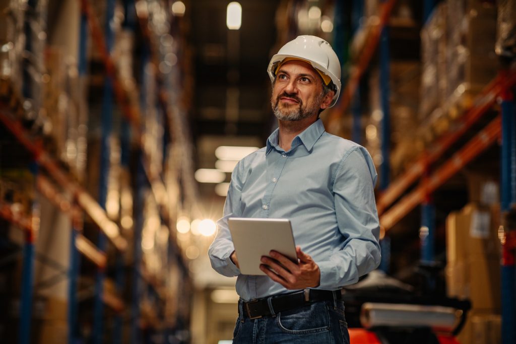 Man with stock management solution software in a warehouse