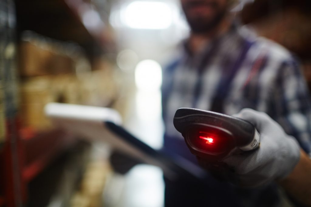 Man using barcode scanner for warehouse management
