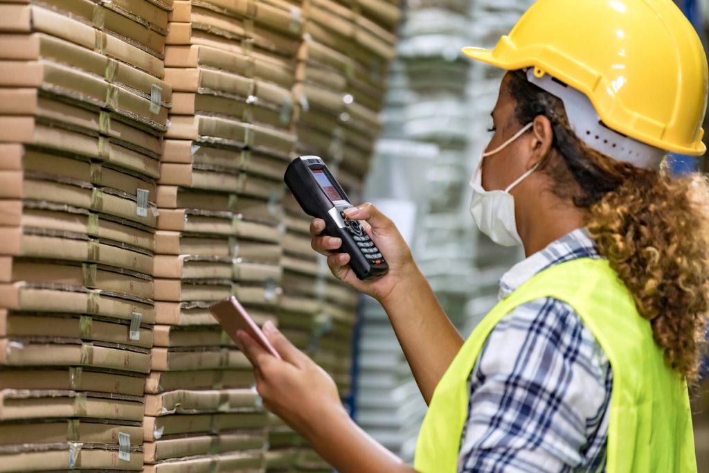 Woman using handheld device for stock management