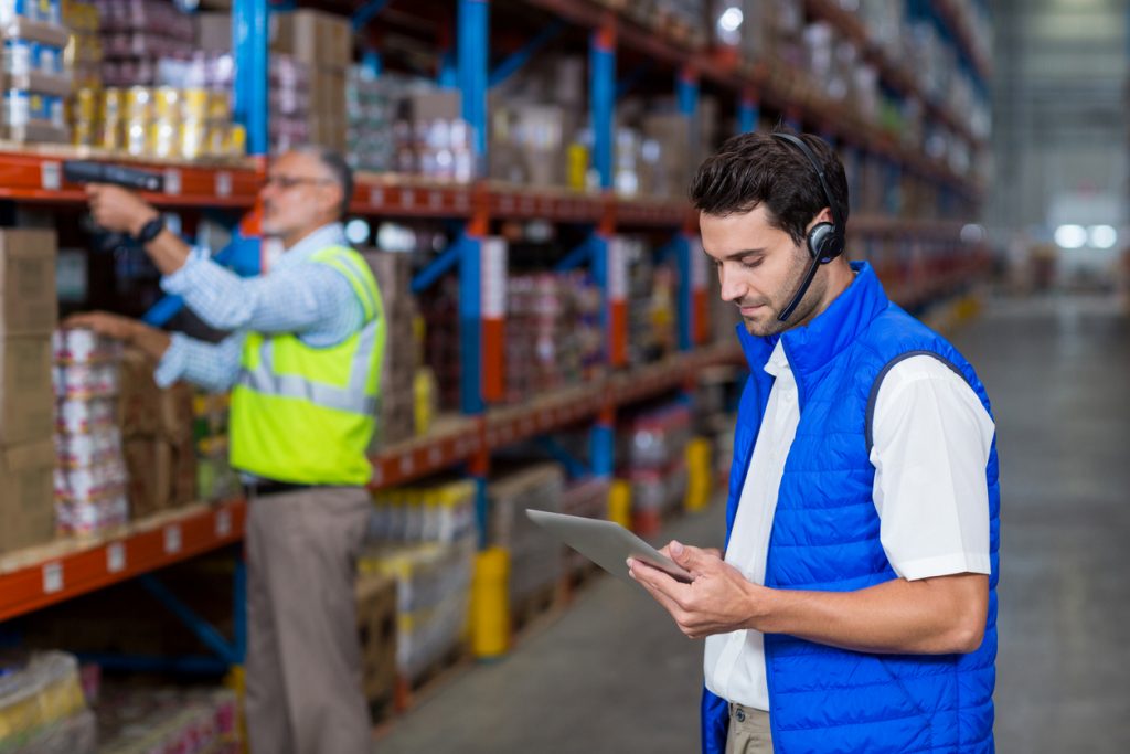 Warehouse worker using a mobile device in the warehouse