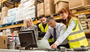 Warehouse workers looking at stock control system