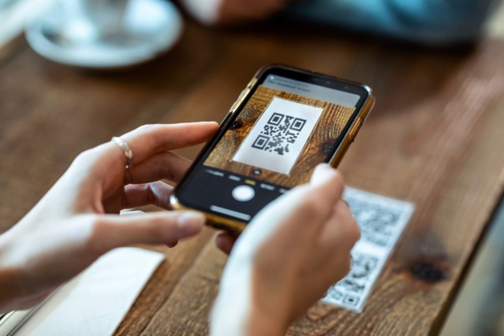 Person scanning a QR code on a table