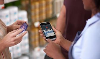 workers looking at zebra mobile device