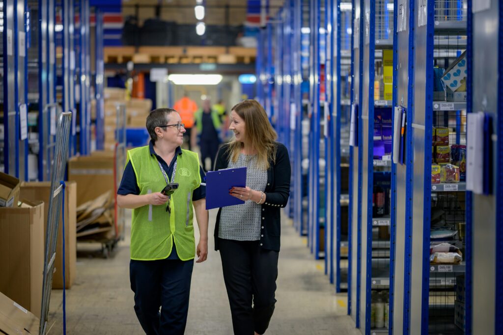 Two people in a warehouse scanning barcodes
