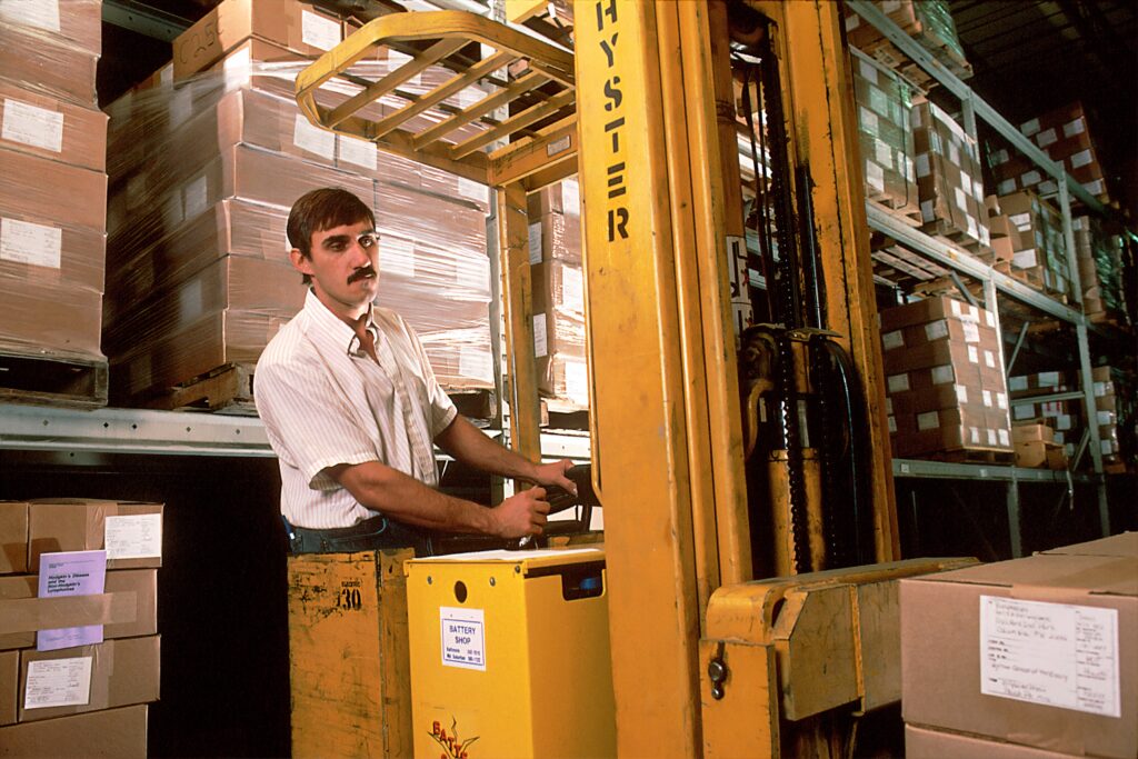 man operating warehouse machinery